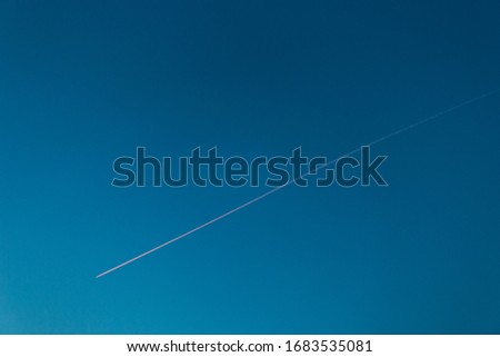 airplane passing by with no clouds skyview Royalty-Free Stock Photo #1683535081