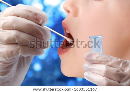 doctor takes a cotton bud from child’s mouth to analyze the saliva, mucous membrane for DNA tests, COVID-19, to determine paternity or presence of virus, SARS-CoV-2 epidemic, coronavirus concept Royalty-Free Stock Photo #1683551167