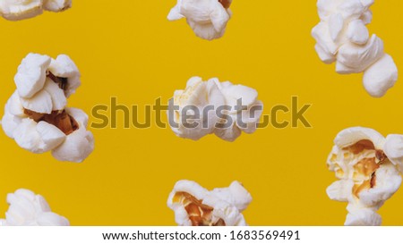 Close up of popcorn on yellow background. Macro photo.