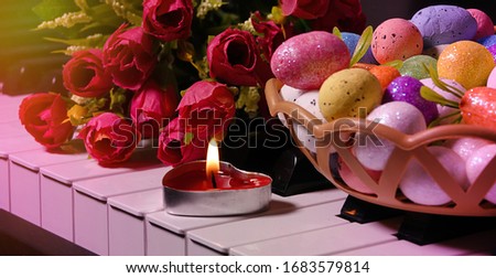 Colorful Paschal Easter Eggs and Piano Keys and Flowers