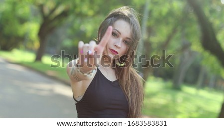 
Attractive young woman blocking with hand and gesturing NO with finger. Stop signal