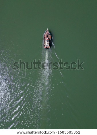 Aerial view fisherman boat. The fisherman goes alone in his boat