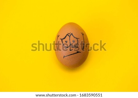 drawing face on egg isolated on yellow background