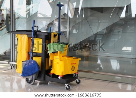 Closeup of janitorial, cleaning equipment and tools for floor cleaning at the airport terminal. Royalty-Free Stock Photo #1683616795