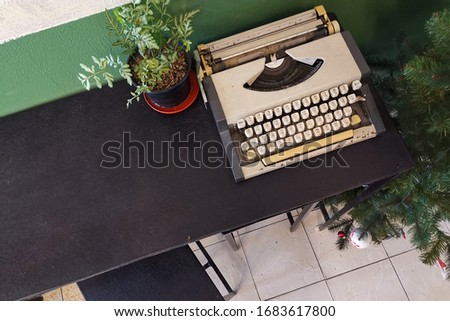 Vintage retro classic typewriter in cafe against wooden table