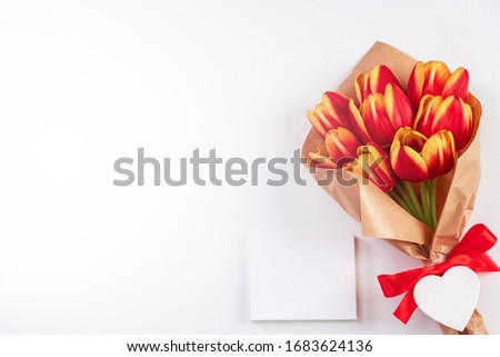 Mother's Day Design Concept, Tulip flower bunch, - Beautiful Red, yellow bouquet isolated on bright white background table, top view, flat lay, copy space