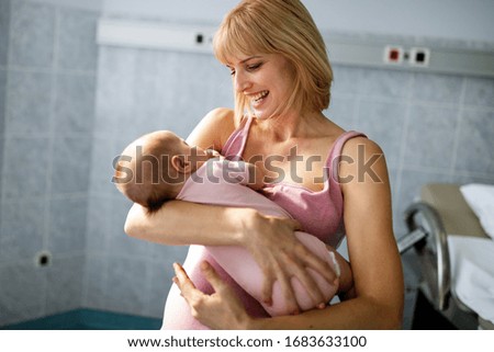 Picture of happy mother playing with sweet baby girl