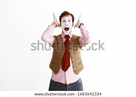 A portrait of a man, an actor, a pantomime, a man makes a panic, aggression gesture. Emotions, facial expressions, feelings, body language, signs. Image on a white studio background