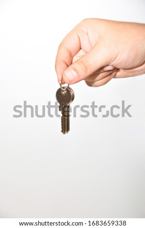 Chrome metal modern home door key on ring, isolated on white background