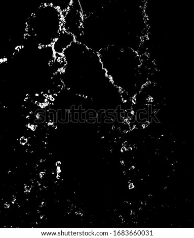 Splashes and drops of water are isolated on a black background.