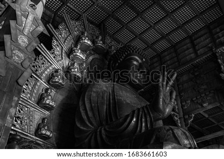 A black and white picture of the Great Buddha statue, the main attraction of the Todai-ji Temple.