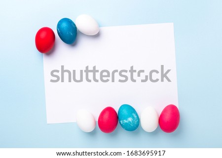 Spring mockup with Easter eggs and blank of white paper on blue background. Easter concept. Copy space. Top view - Image