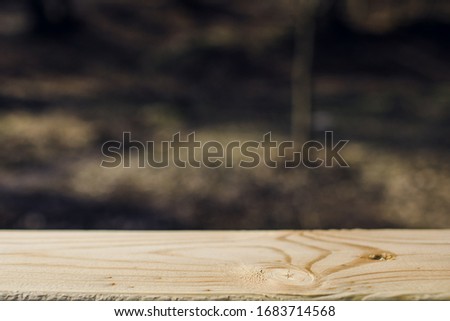Wood table top on blur abstract green from garden in the morning background.For montage product display or design key visual layout