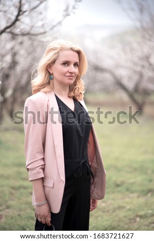 Girl in a blooming apricot garden. Film Grain Shooting