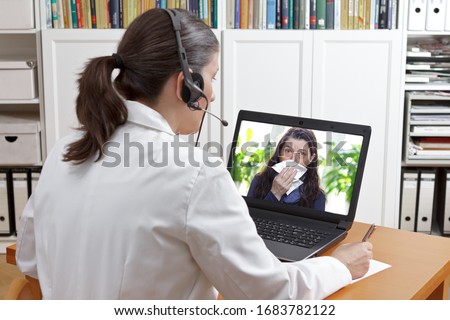 Telemedicine concept: doctor or pharmacist with headset during a video consult with a patient with the flu. Royalty-Free Stock Photo #1683782122