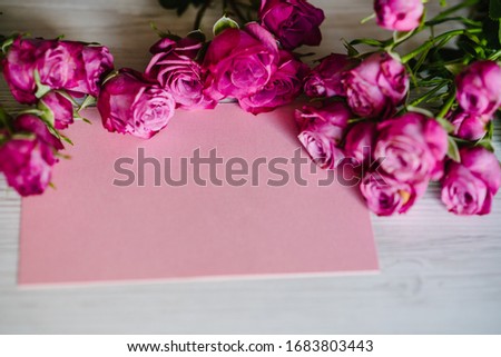Postcard with composition of pink roses on wooden background. Space, text message. Holiday greeting card for Valentines, Women's, Mother's Day! Top view, flat lay. Happy Birthday. Wedding invitation.