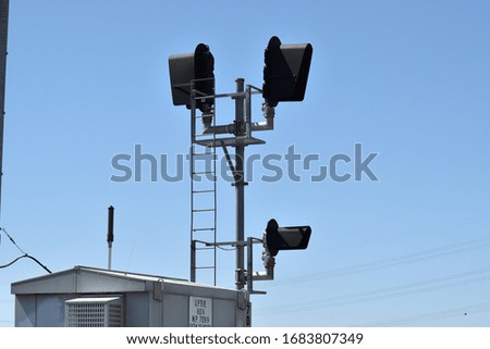 Train rail traffic signal on sunny day.