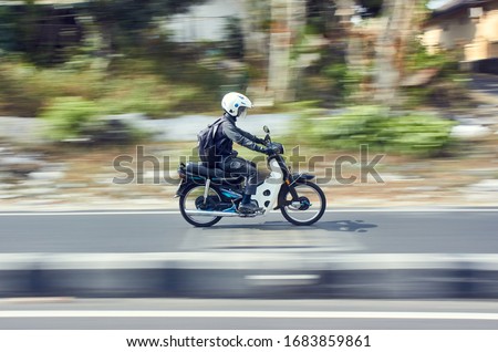 Fast moving moped with panning technique Royalty-Free Stock Photo #1683859861