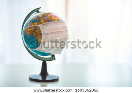 Prevent COVID-19 concept. Earth globe with medical disposable face mask. COVID 19 or ecological disaster concept. Globe with a face mask. Planet Earth with face mask protect. World medical concept. Royalty-Free Stock Photo #1683862066