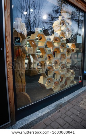 Beautiful wooden shelves in the form of honeycombs. Shop window on the street. Exhibition area.