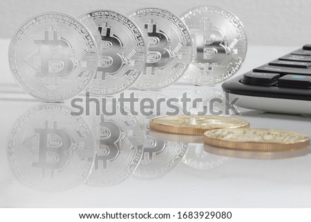 Bitcoins on the reflective marble desk, closeup. Cryptocurrency virtual money. Exchange, anonymous. Bitcoin is an open source web cash currency.