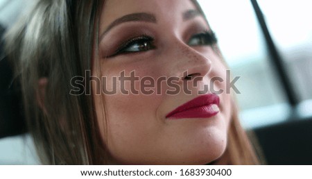 
Hispanic girl face in backseat car smiling looking to camera
