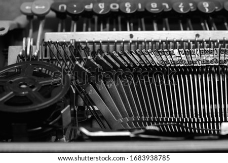 Mechanism and keyboard of an old typewriter with a film coil.In black and white image
