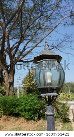 Close up picture of an old fashion lamppost or lamp post in a garden.