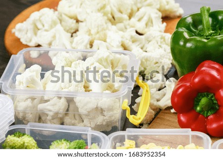 Raw cauliflower in tray for freezing. Stocking up for winter storage in plastic containers
