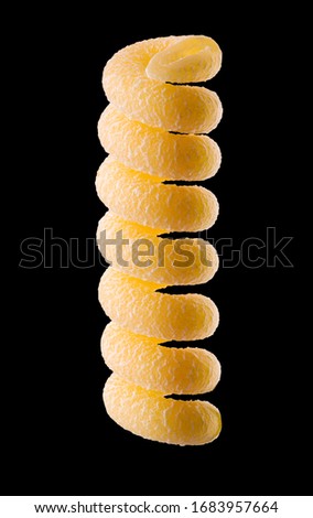 Macro photo of yellow fusilli pasta isolated on black background with clipping path.
