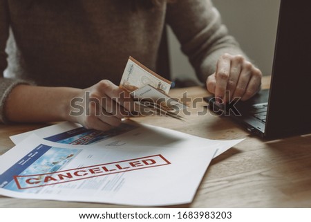 Woman Counting Money of Cancelled Travel Expenses Royalty-Free Stock Photo #1683983203