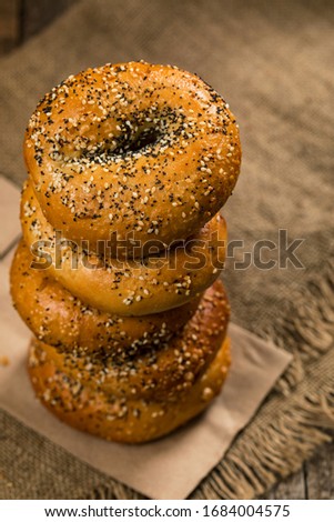Bagels Topped with Sesame Seeds, Poppyseeds, Garlic and Onion on Wooden Background. Selective focus.