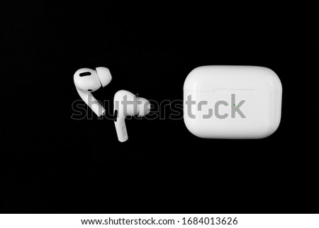 Air Pods Pro. with Wireless Charging Case. New Airpods pro on black background. Airpods Pro. Copy space Royalty-Free Stock Photo #1684013626