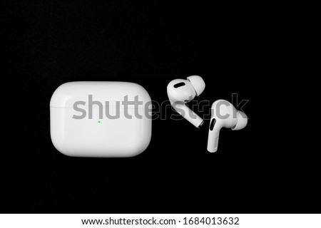 Air Pods Pro. with Wireless Charging Case. New Airpods pro on black background. Airpods Pro. Copy space Royalty-Free Stock Photo #1684013632