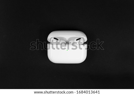 Air Pods Pro. with Wireless Charging Case. New Airpods pro on black background. Airpods Pro. Copy space Royalty-Free Stock Photo #1684013641