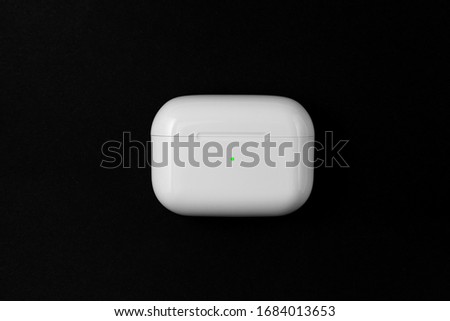 Air Pods Pro. with Wireless Charging Case. New Airpods pro on black background. Airpods Pro. Copy space Royalty-Free Stock Photo #1684013653