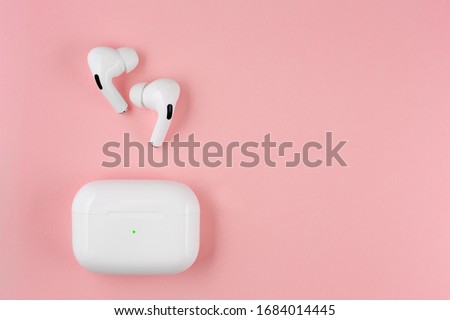 Air Pods pro. with Wireless Charging Case. New Airpods pro on pink background. Airpodspro. female headphones. entangled 3.5 headphones. Copy Space Royalty-Free Stock Photo #1684014445