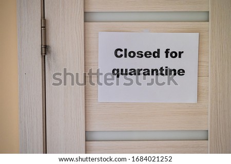 The inscription on the door is “closed for quarantined”. Coronavirus epidemic. Pandemic of the 21st century.