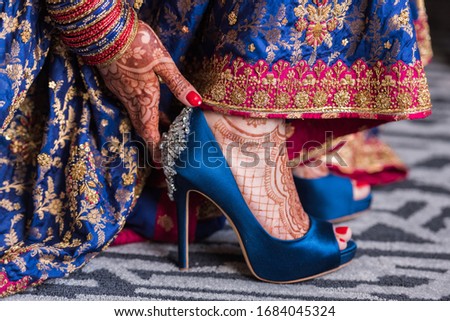 Pair of Pantone Classic Blue Wedding Shoes worn by Indian Bride with henna on her feet