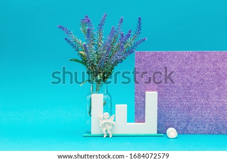 Letter object with lavender and angel object with a shiny purple and blue background