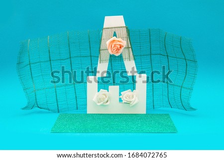 Letter objects with flowers, roses and decorations on a blue background