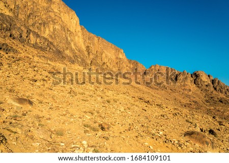 Middle East or Africa, picturesque bare mountain range and a large sandy valley desert landscapes landscape photography. Horizontal frame