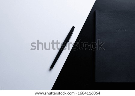 Black style set: notepad and pen on Black background.