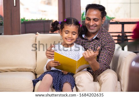 Father helping his daughter in studies , teaching her  Royalty-Free Stock Photo #1684202635