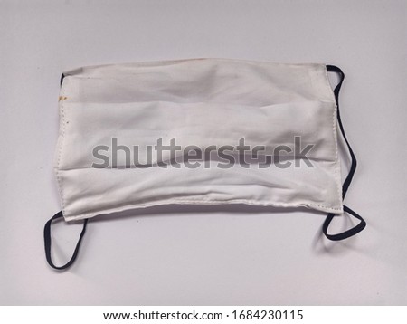 White cloth mask that has been used. Isolated on white background

