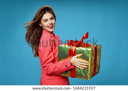 Beautiful woman with a gift box and a pink jacket
