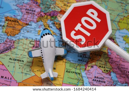 Airplane Traffic Limitations. Air traffic stopped.Air travel prohibited.Ban on air travel.Coronavirus epidemic problem. Decorative airplane and stop sign on world map background.Flying on a plane Ban Royalty-Free Stock Photo #1684240414