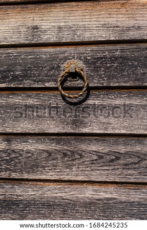 Old wooden door with metallic doorlock