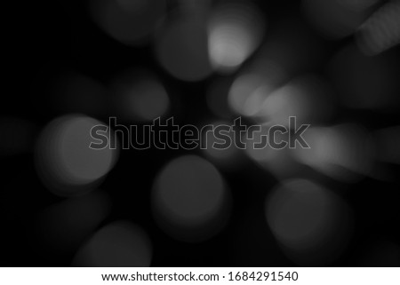  abstract background of blurred white bokeh is on  black background that is dispersing.