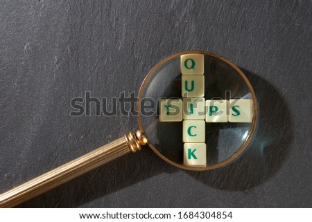 magnifying glass on words of business marketing collected in crossword cubes